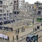 Forces loyal to Syria's President Bashar al-Assad supervise the evacuation process of rebel fighters from the Old City of Homs